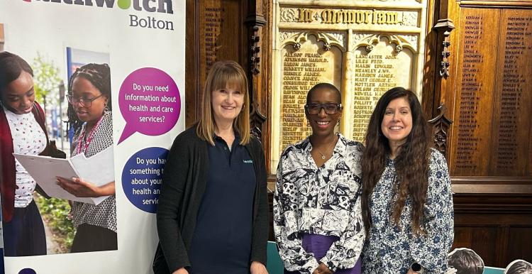 3 ladies standing by a Healthwatch Bolton banner