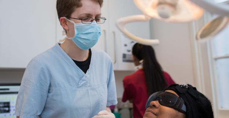 A dentist with a patient in a dentist chair