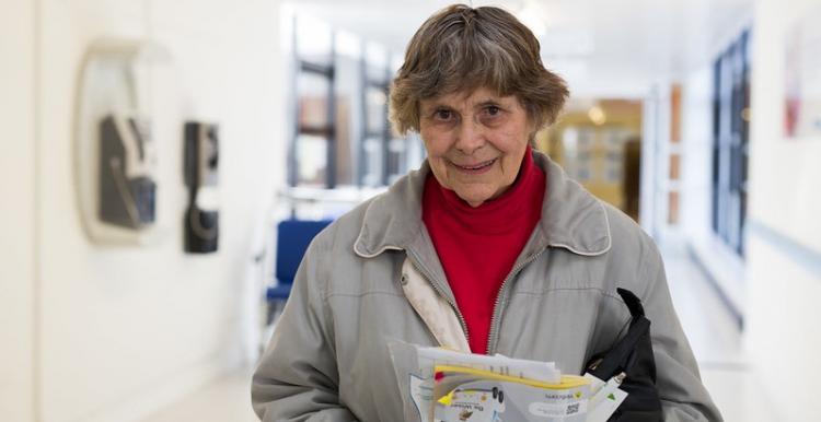 older lady with leaflets