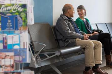 Two people talking in a waiting room
