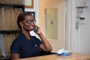 A health professional lady on the telephone wearing glasses