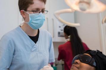 A dentist with a patient in a dentist chair