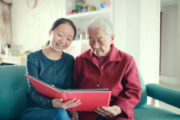 Two women reading together in a care home