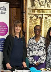 3 ladies standing by a Healthwatch Bolton banner