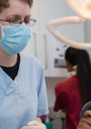 A dentist with a patient in a dentist chair