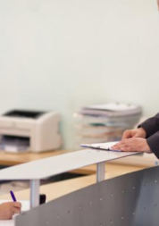 Female receptionist talking on the phone while patient waits