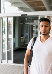 young man waiting outside of a hospital